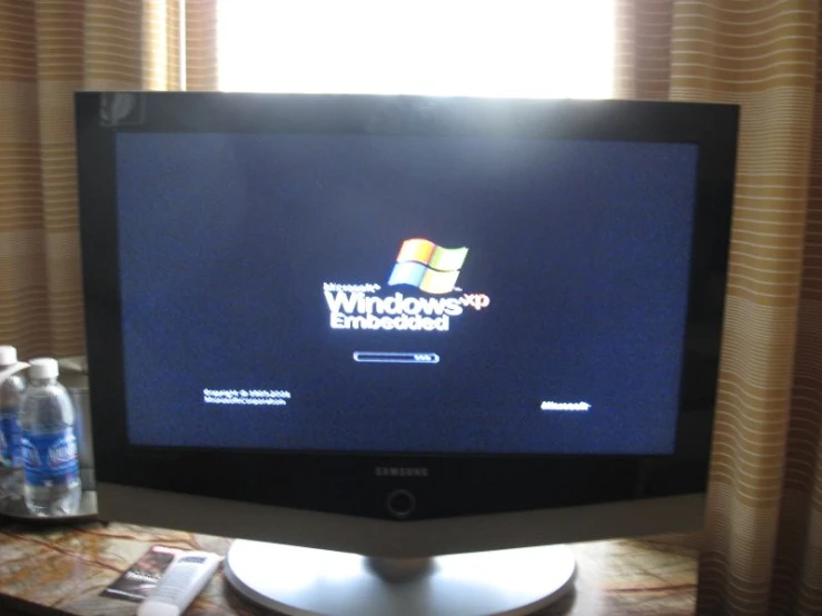a desktop computer with a windows 7 logo displayed on it