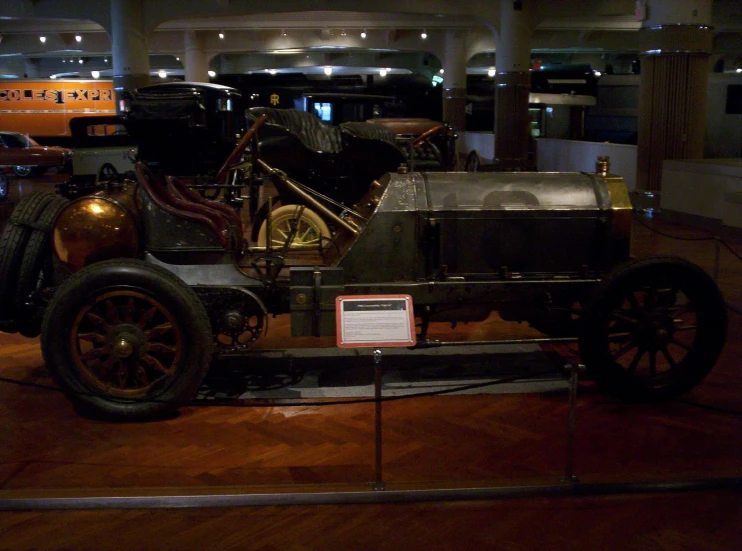 an old - fashioned motor car on display in a building