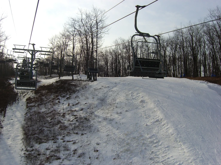 a ski lift going over snow covered hills