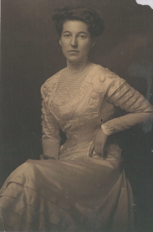 an old po of a woman wearing a dress