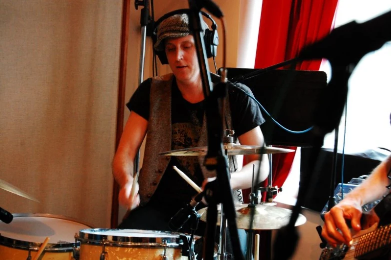 a man playing drums in a recording studio