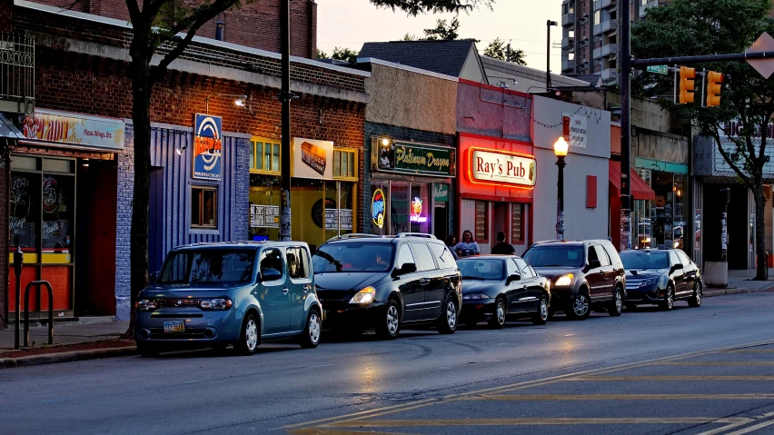a row of parked cars along side a city street