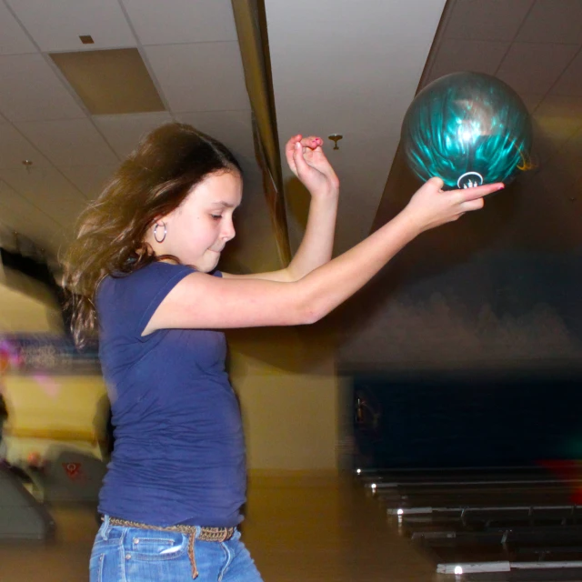 a girl is spinning a glass bowl around