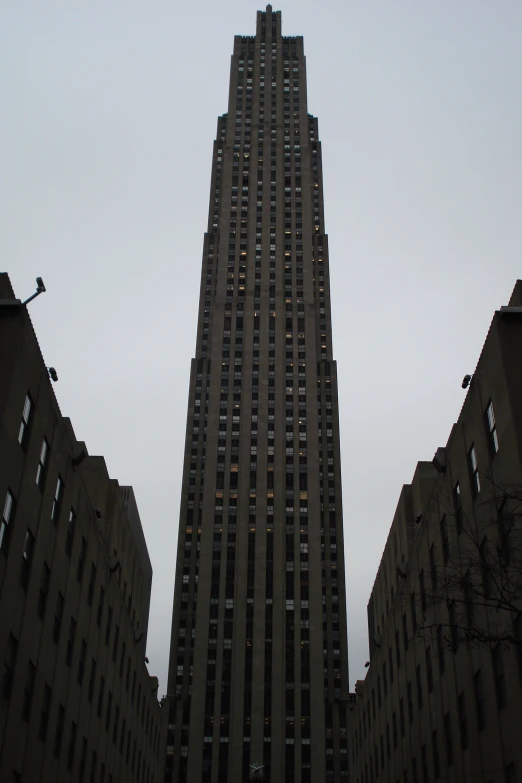 a tall building is surrounded by tall buildings