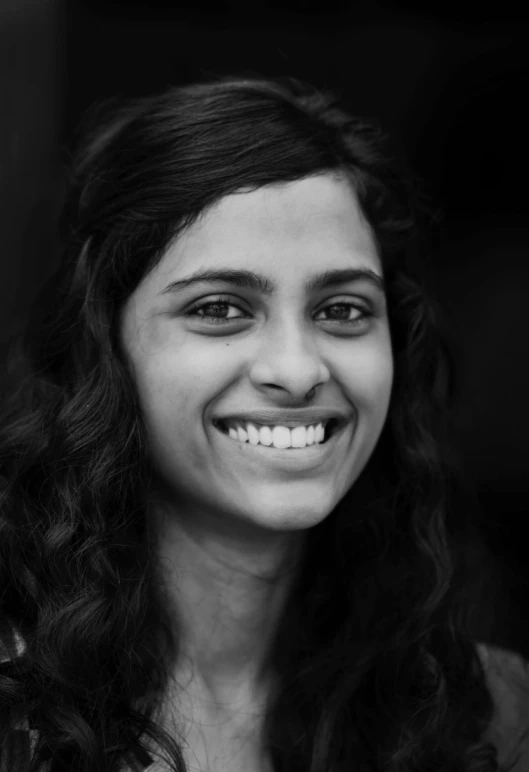 a woman smiling with her teeth open