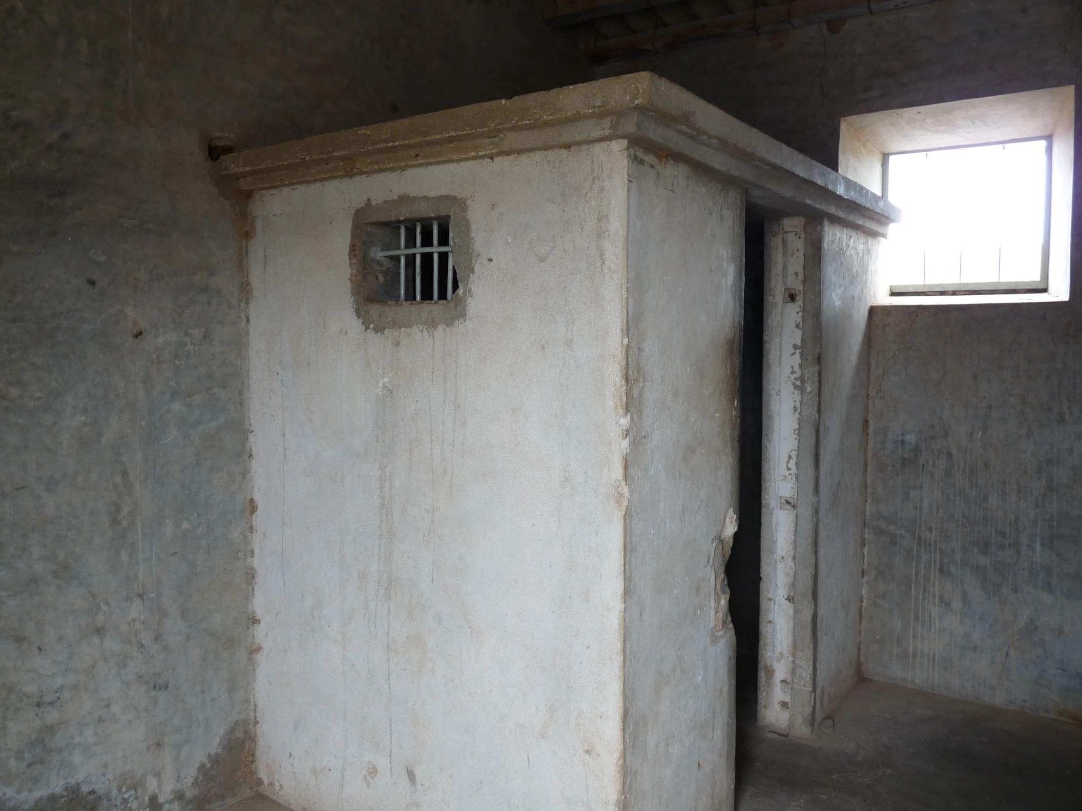 an old concrete house with a window