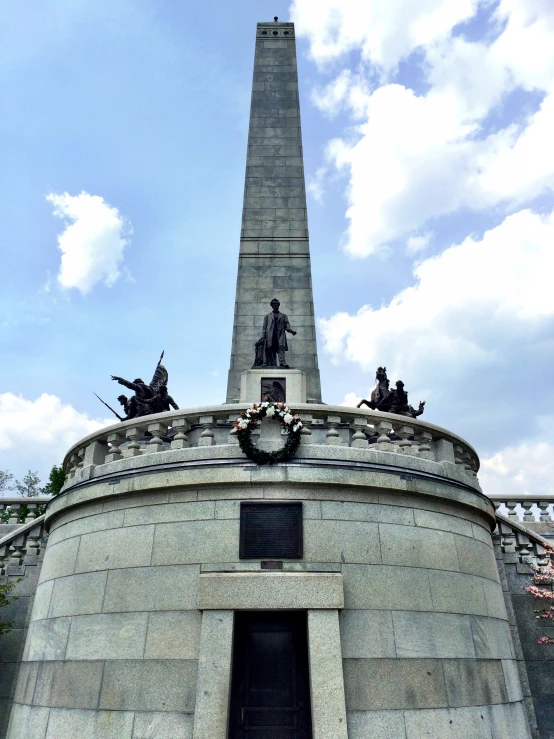 a monument with a stone monument with sculptures around it