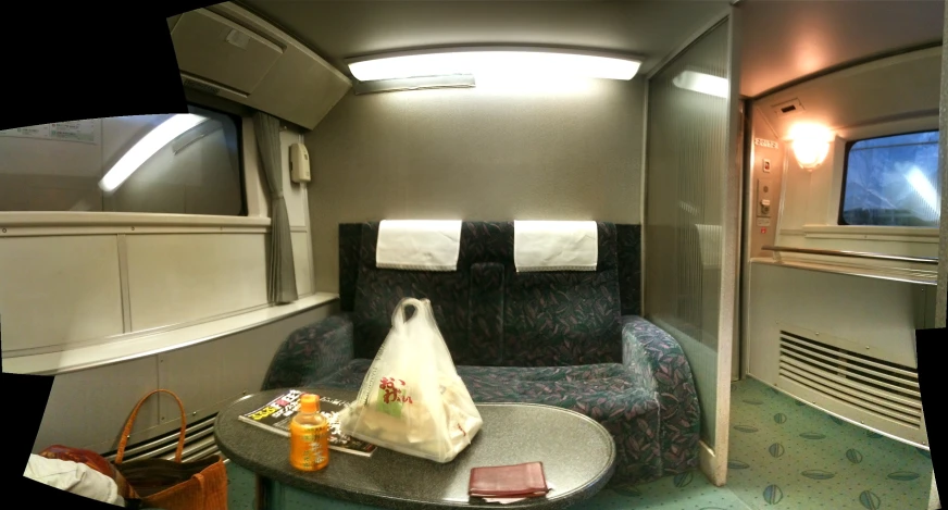 an airplane room with a table, chair and window