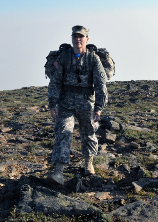 soldier standing in the middle of a rocky mountain