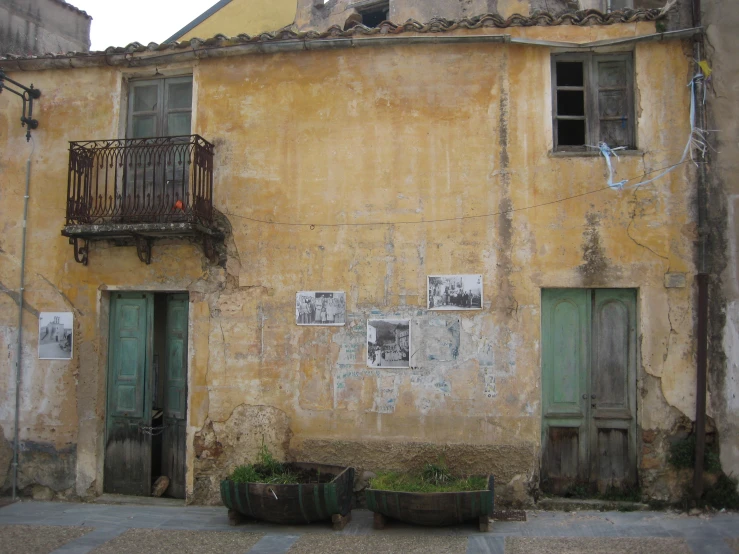 the wall of the building has old balconies