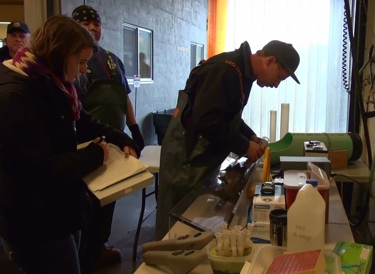 men wearing military attire look at samples and papers