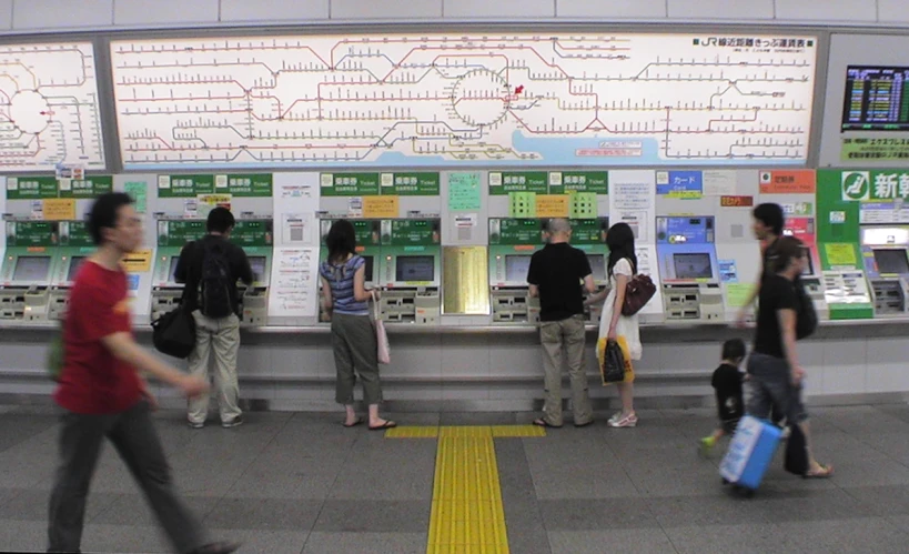 a group of people waiting for the subway to stop