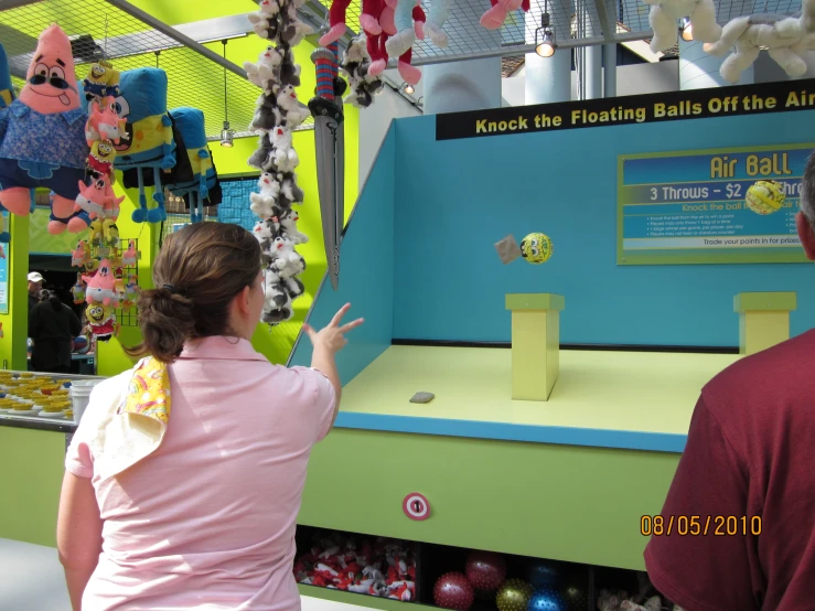 two people looking at a display of teddy bears