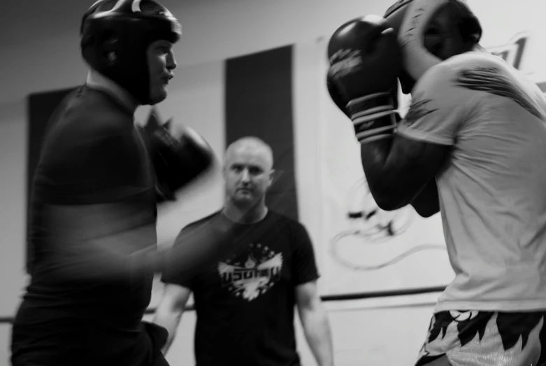 the men are getting ready to use their boxing gloves