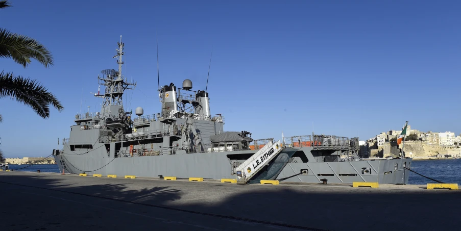 an old military boat that is docked in the water