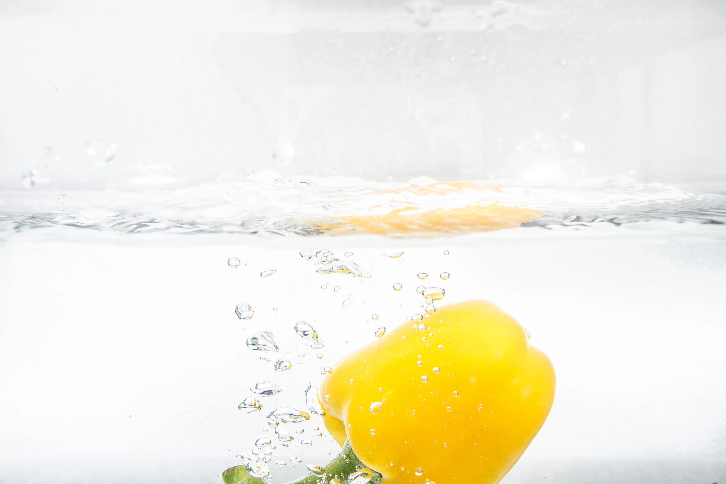 the lemon is floating in the water next to the water surface