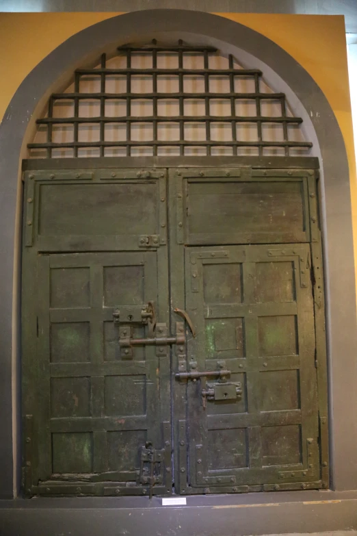 the large doors are locked in an archway