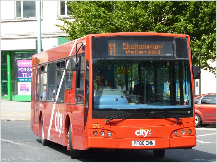 an orange city bus on a busy street