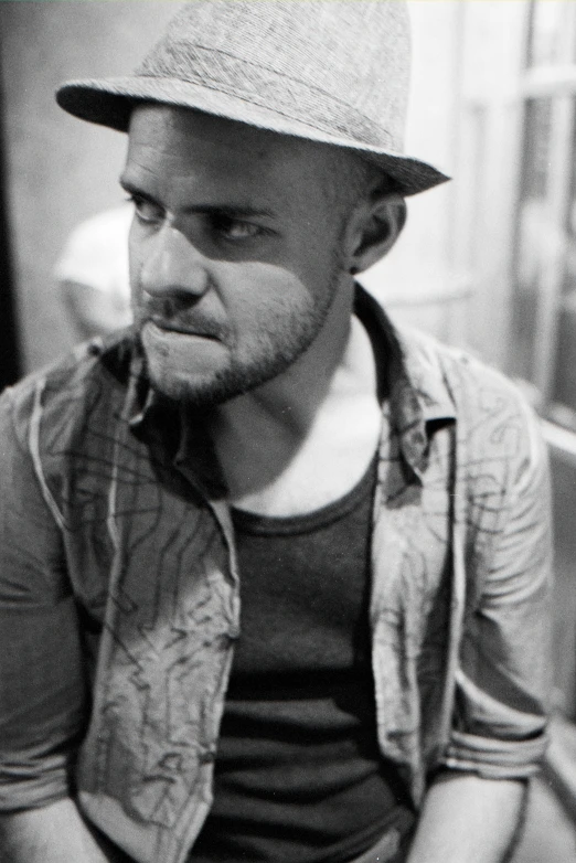 black and white po of a man sitting in front of a table