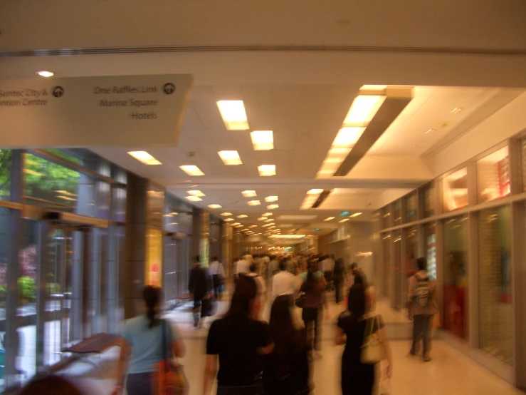 a group of people walking down a long hallway