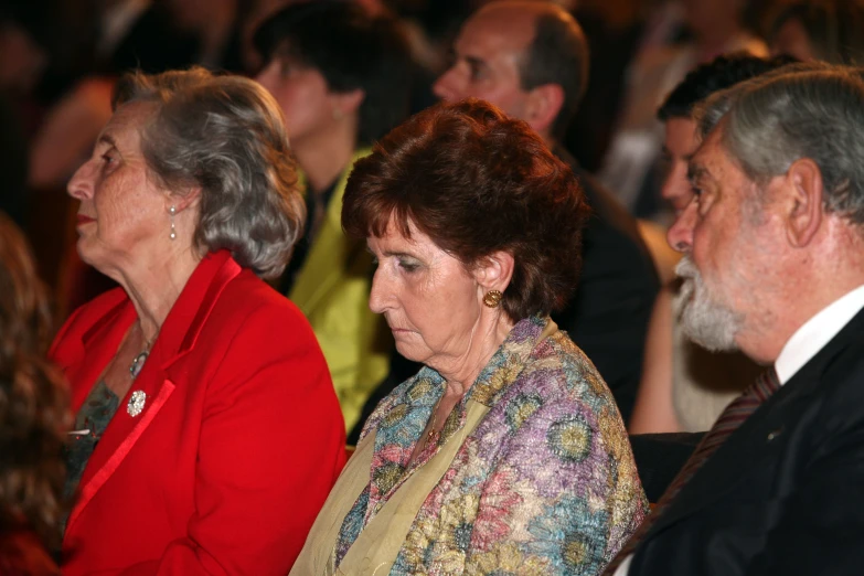 several people sitting in a crowd with microphone