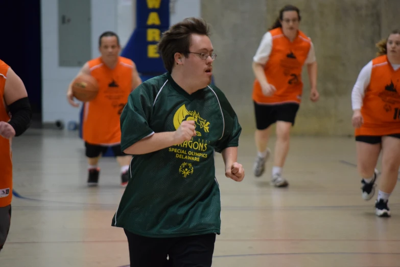 a man is about to throw a frisbee in a gymnasium