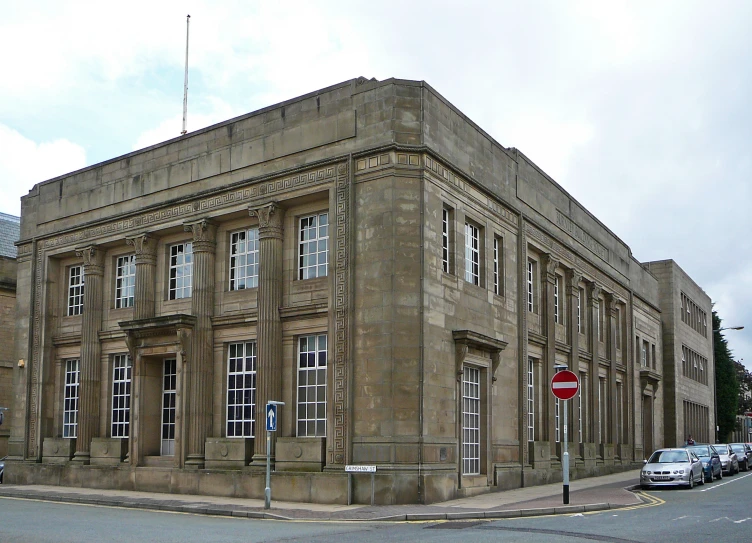 a large building with a flag and traffic sign