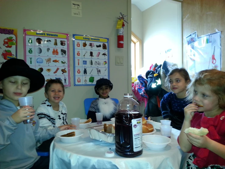 five children eating together with crumbs and jelly