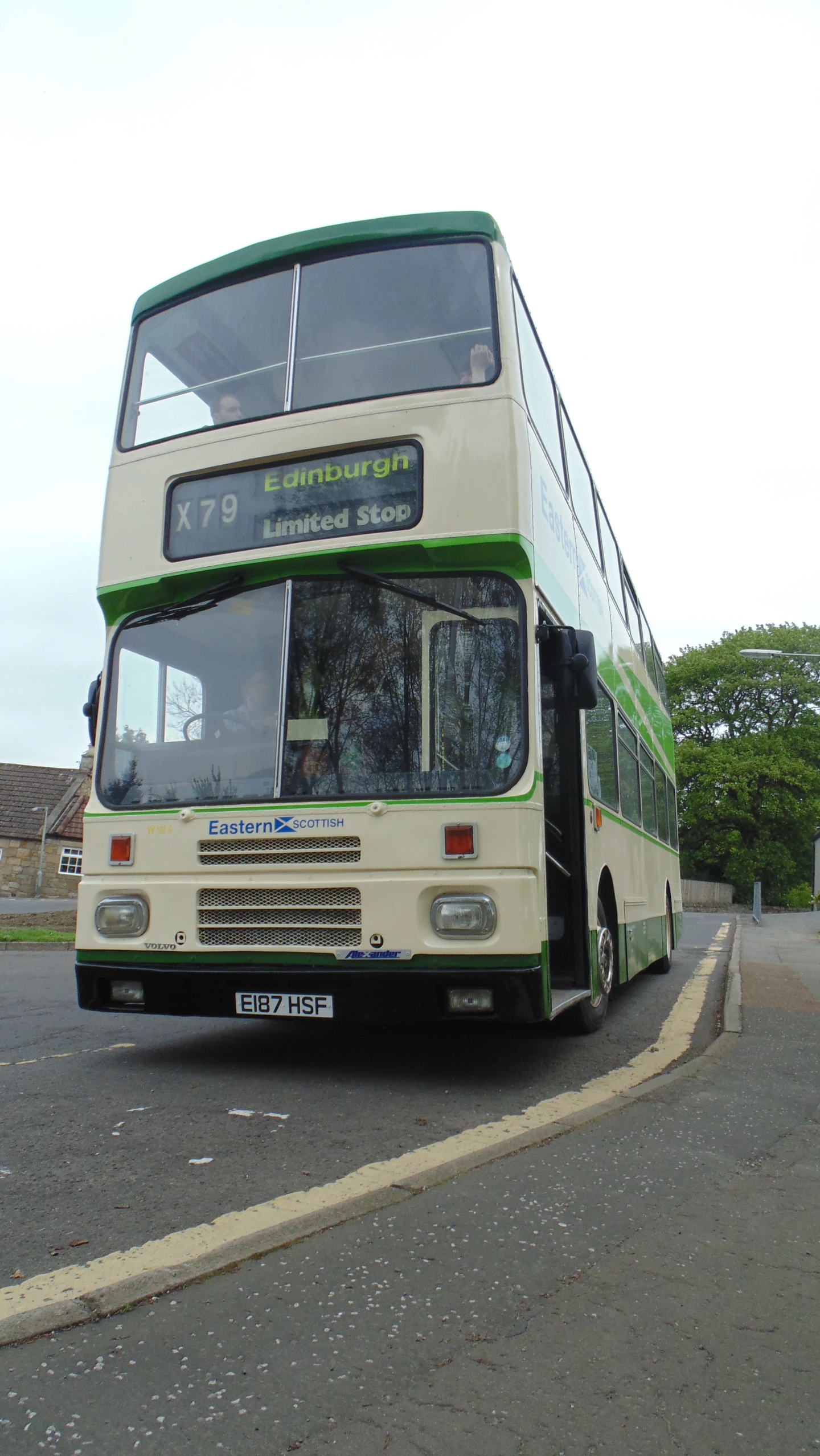 a double decker bus driving down the road