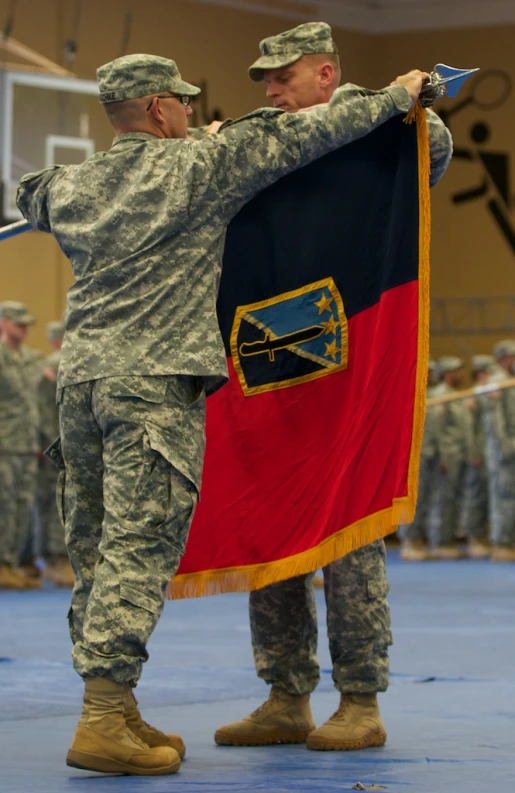 a couple of soldiers holding up a flag