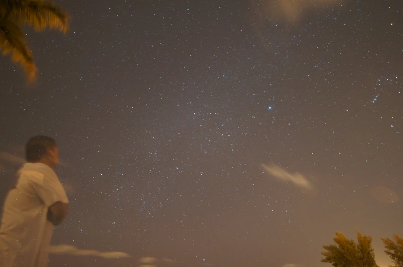 a person looking up at some stars in the sky