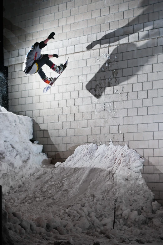 a person on a snow board going down a ramp