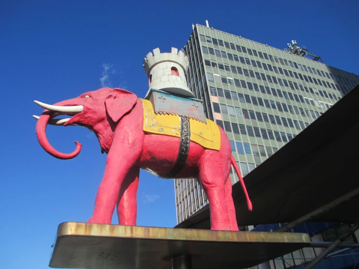 the elephant has been designed in the form of an elephant, against a backdrop of tall buildings