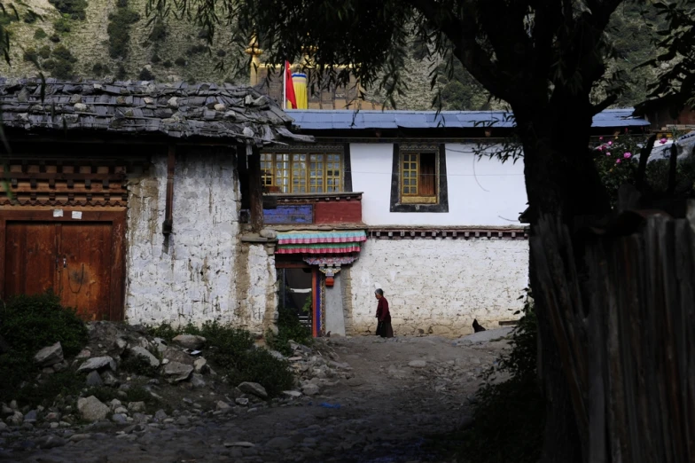 the building has a small tower and a few trees in front