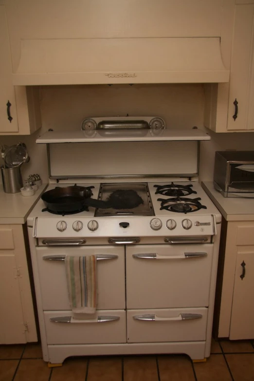 a kitchen with an oven, dishwasher, toaster and microwave