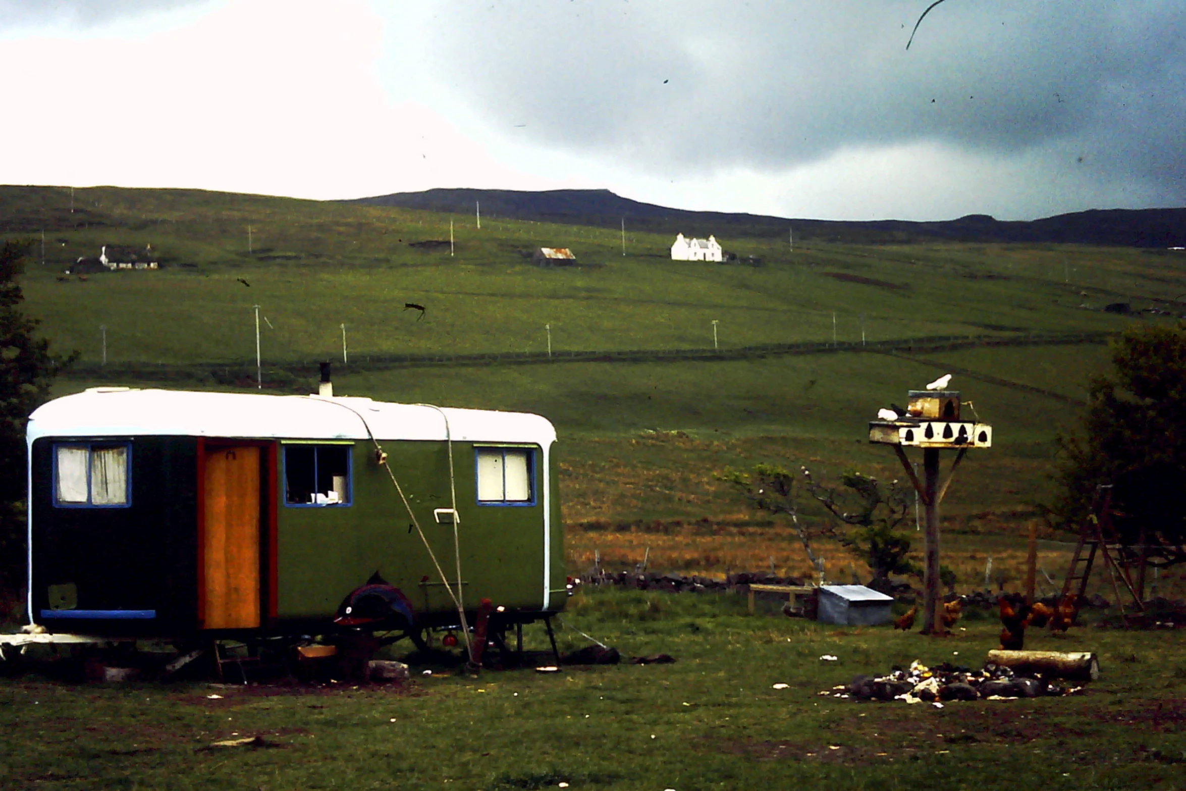 a trailer and a tree in a field