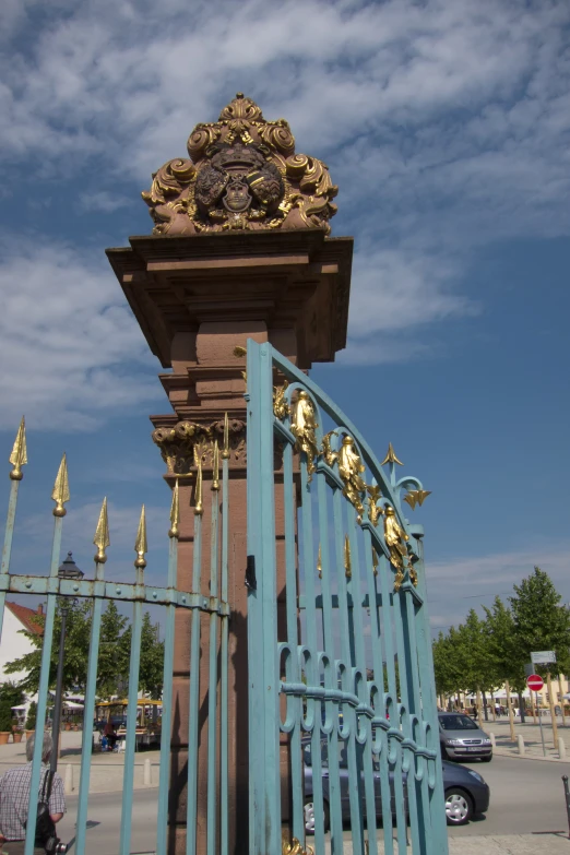 a tall gate with a clock atop top