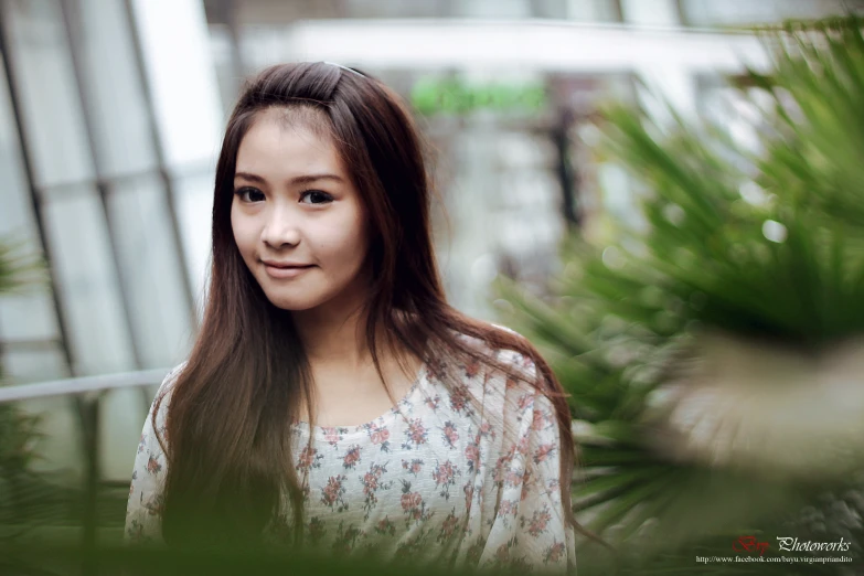 an asian woman is smiling for the camera