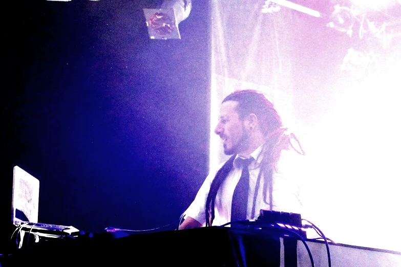 a man at a keyboard performing on stage