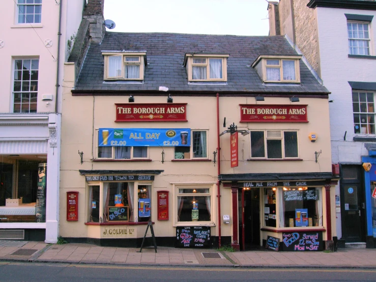 a brick building with various signage and items for sale