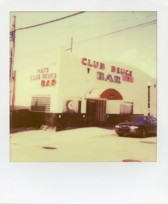 old po of a closed diner with cars parked in front