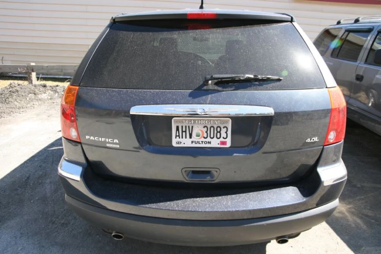 a dark gray toyota suv with a license plate