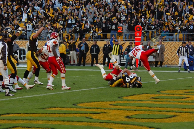 several players in the middle of a play with their arms raised