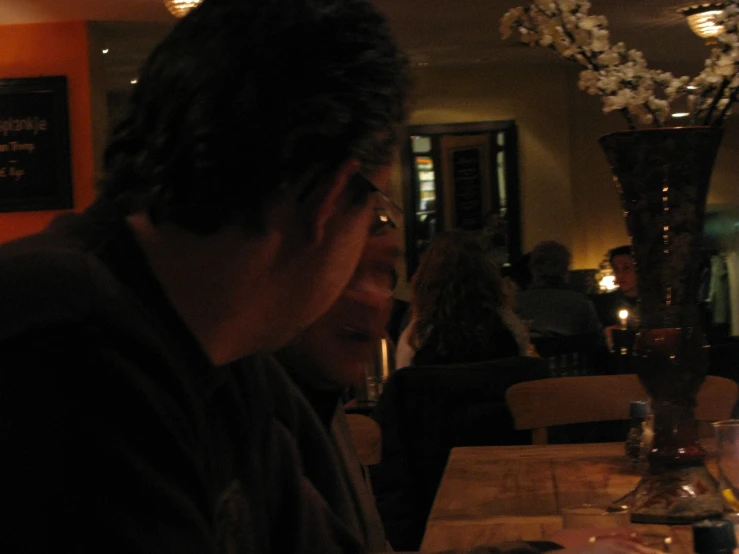 a man sitting at a table with a wine glass