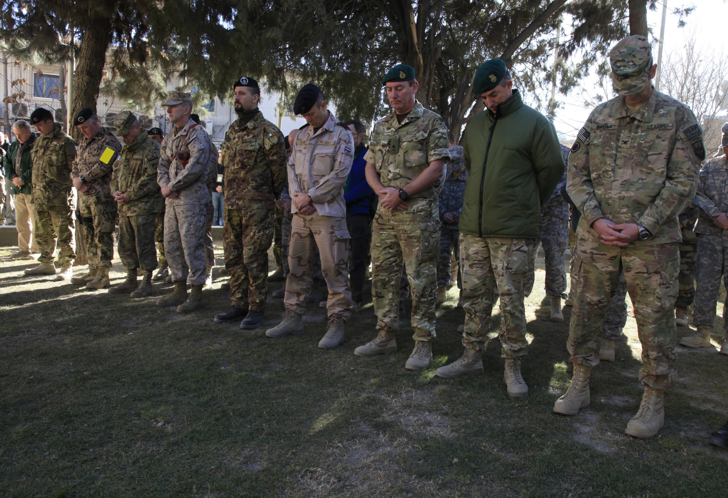 men in uniform are standing and talking near each other