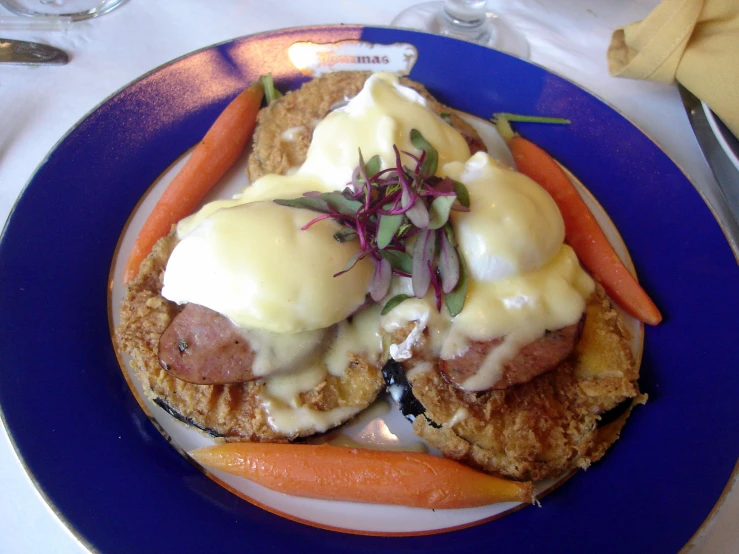 a blue plate holding some meat and vegetables