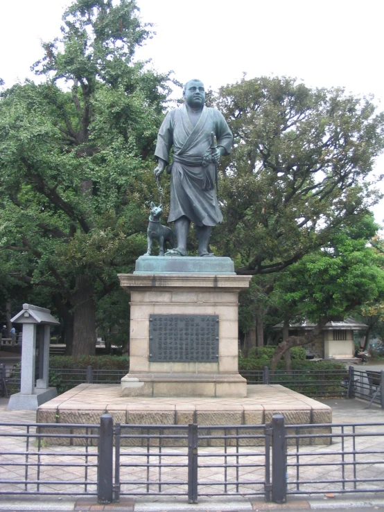 the statue is situated in front of the building