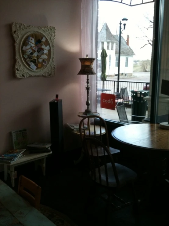 a room with a small table with chairs and a desk in it