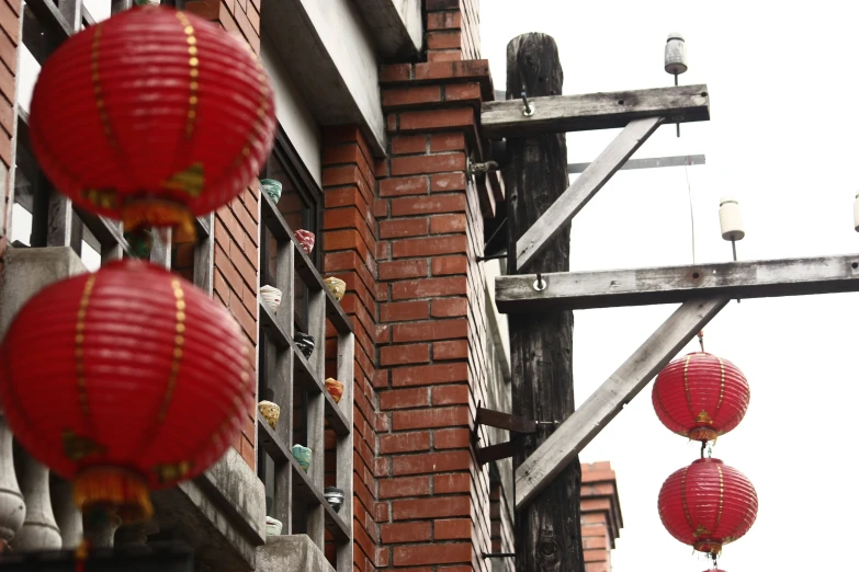 oriental lanterns hang in the sky near a building