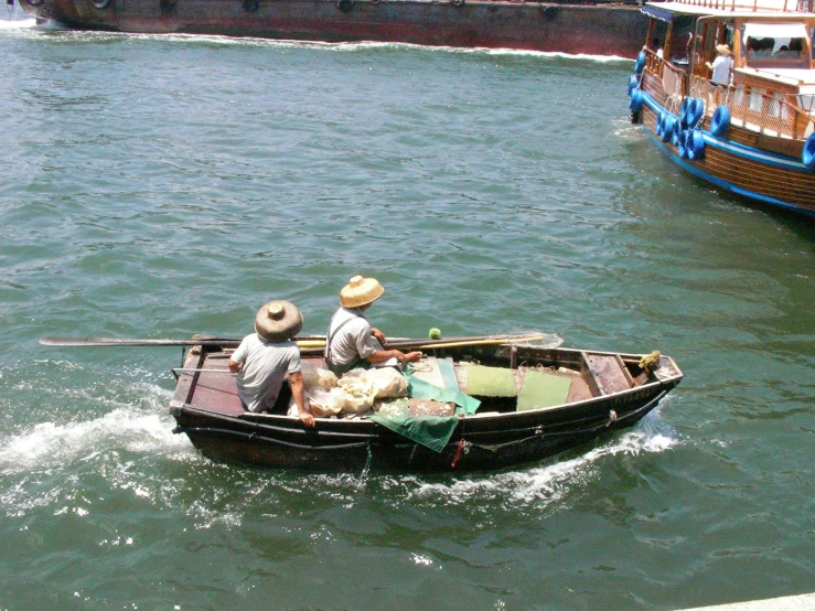 two people in a row boat with dogs and man